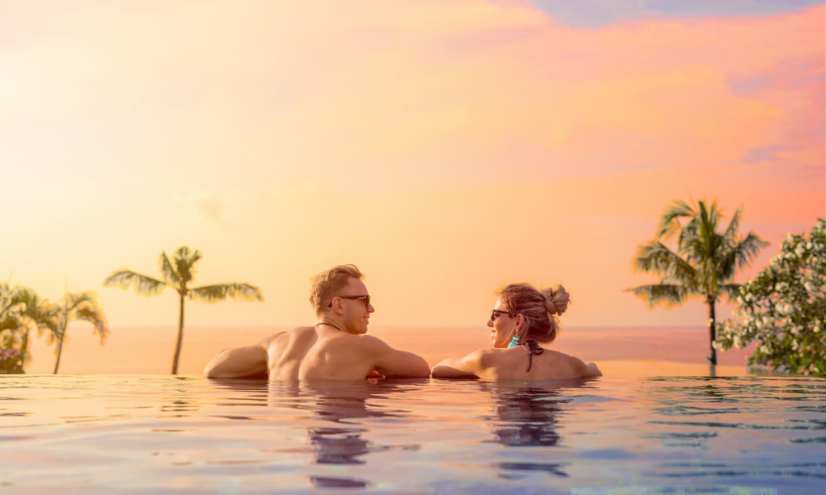 Couple in a pool at sunset