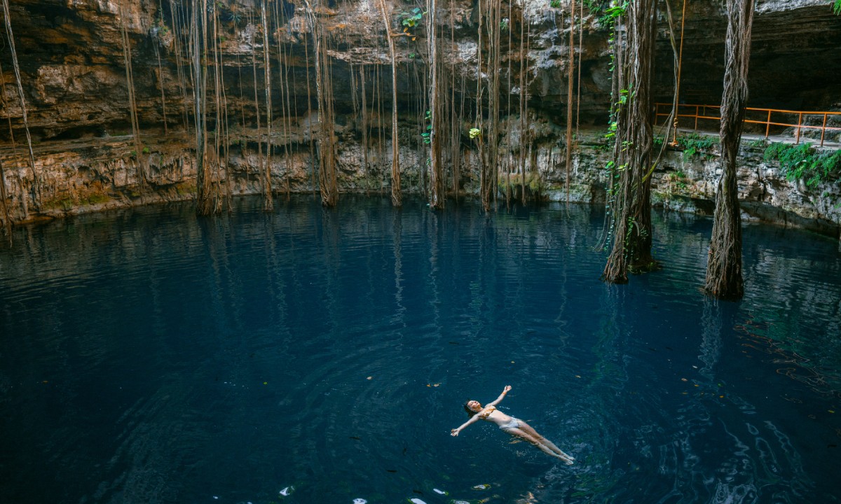 A woman swimming in a cenote