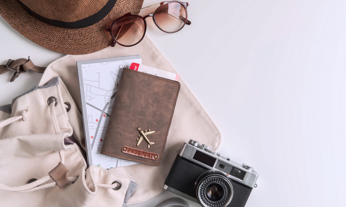 Camera, passport, hat, glasses and travel bag