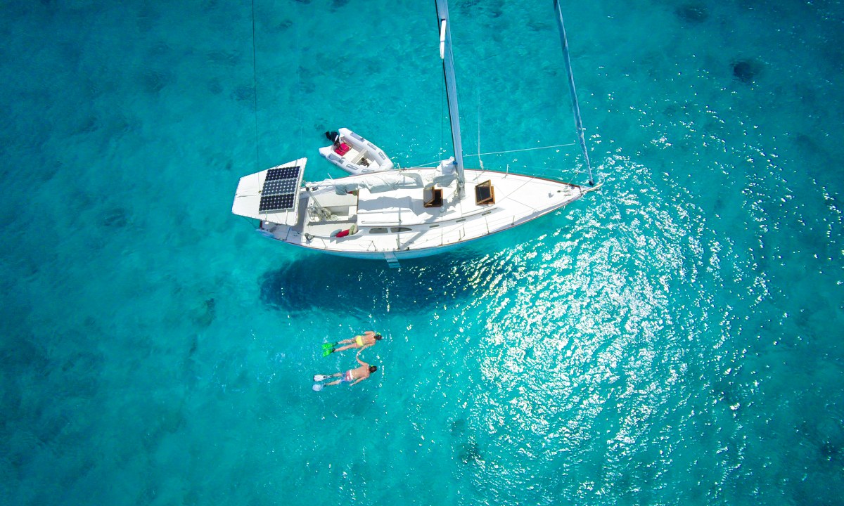 A couple snorkelling by the boat
