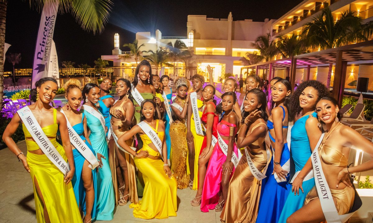 Miss Universe Jamaica contestants posing next to the pool