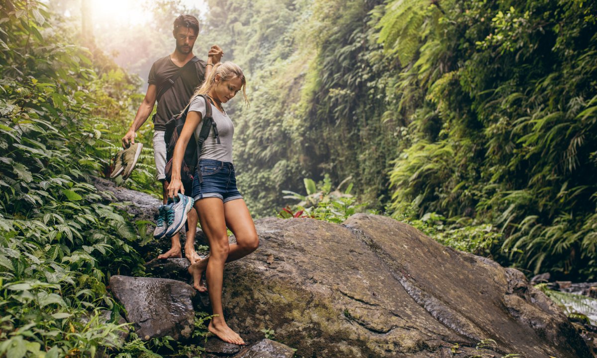 Couple climbing down rocks in the Indigenous Eyes Ecological Reserve