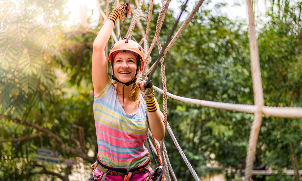 Woman on a zipline at Jamwest Adventure Park