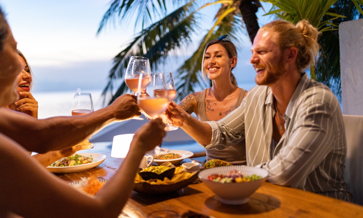 A group of friends raising a glass during dinner