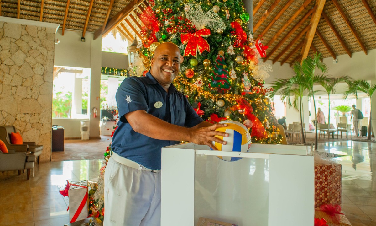 A man donating a ball for the Tree of Happiness
