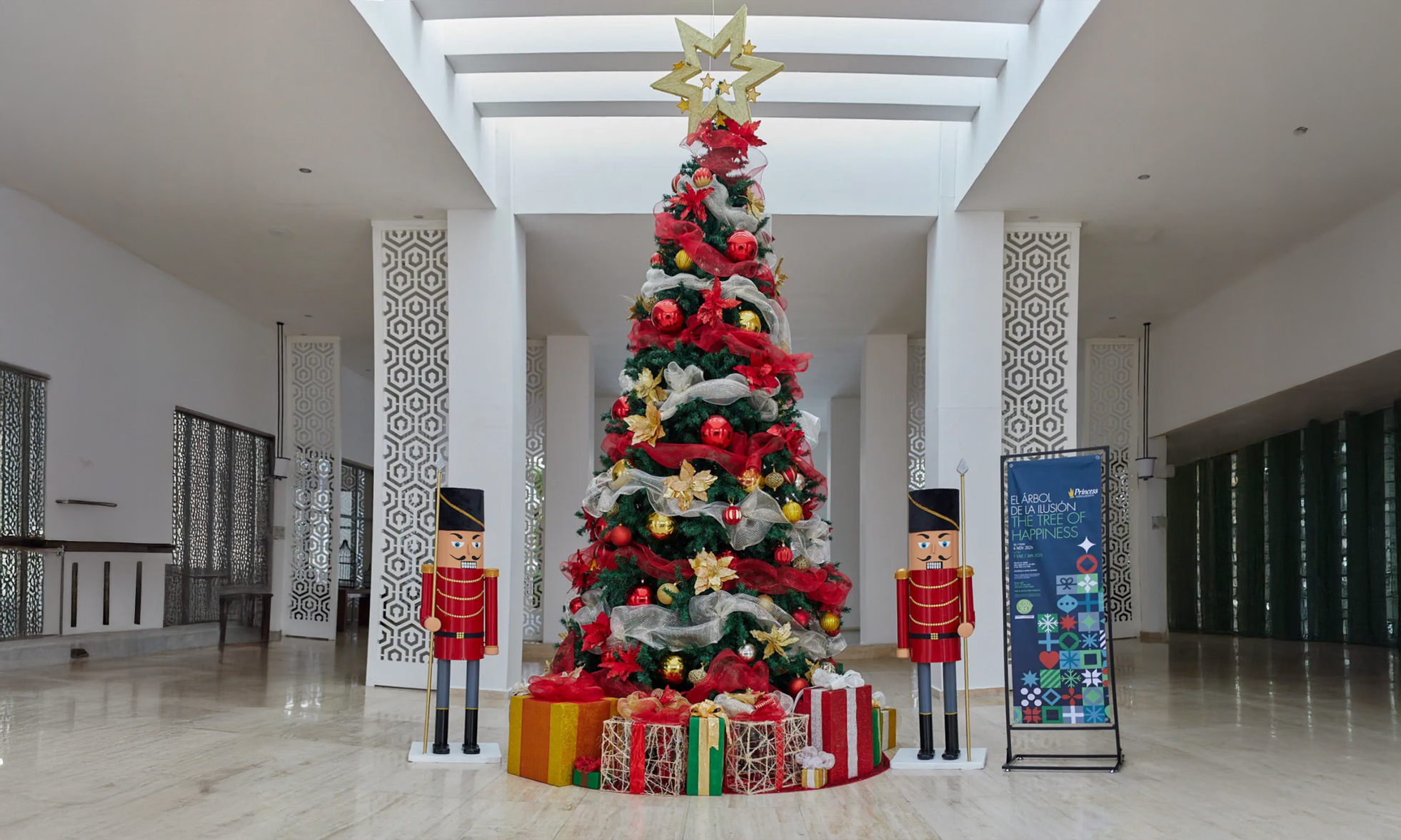 A Christmas tree with gifts in the foyer of the Platinum Yucatan Princess hotel