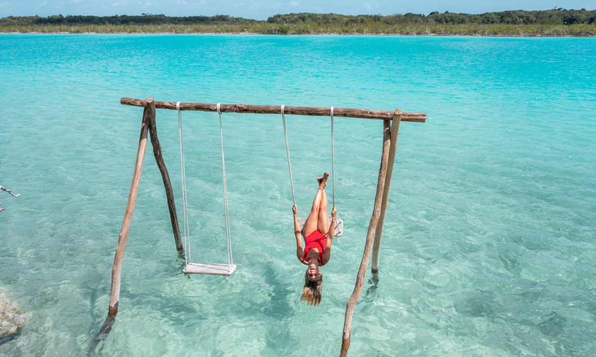 A woman lying on a swing over the sea