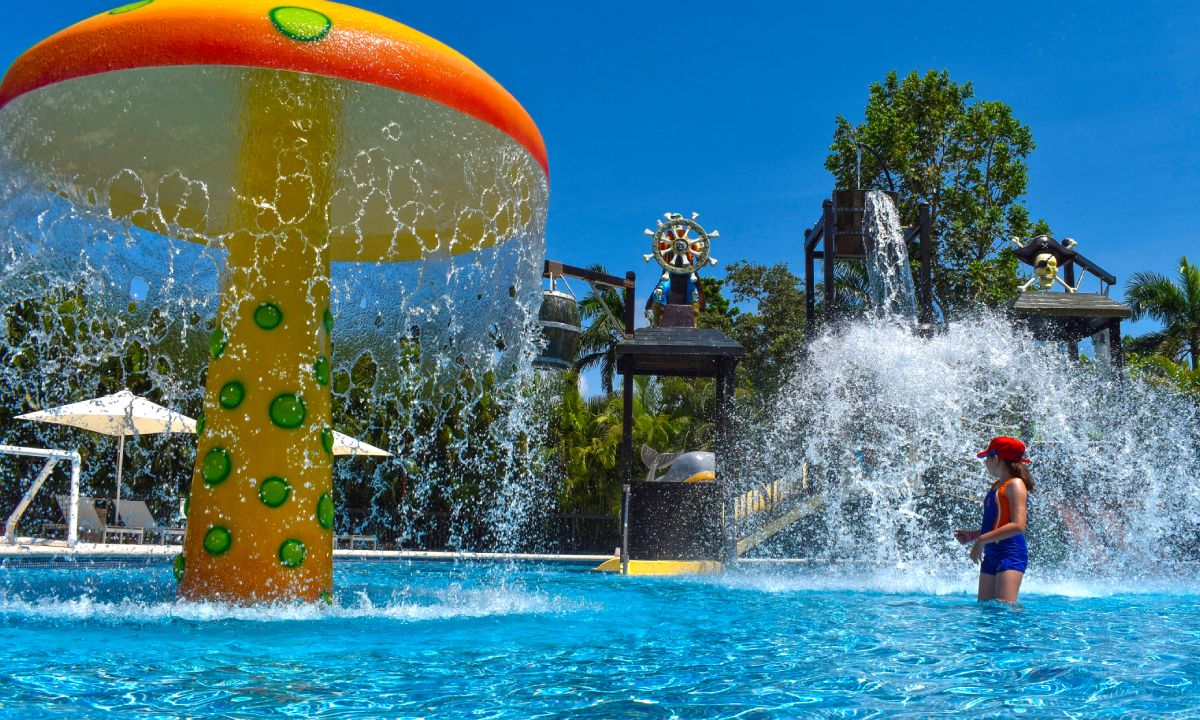 Un hombre y sus dos hijos visitando unas ruinas mayas.