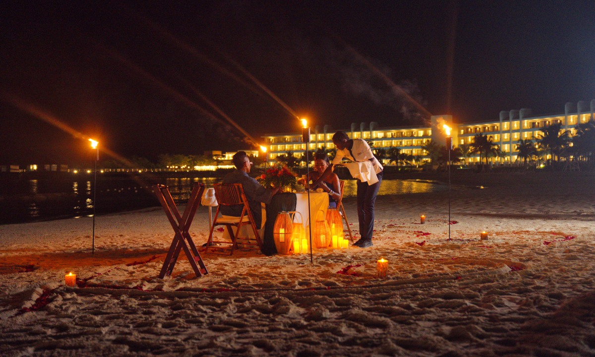 A couple enjoying a romantic seaside dinner