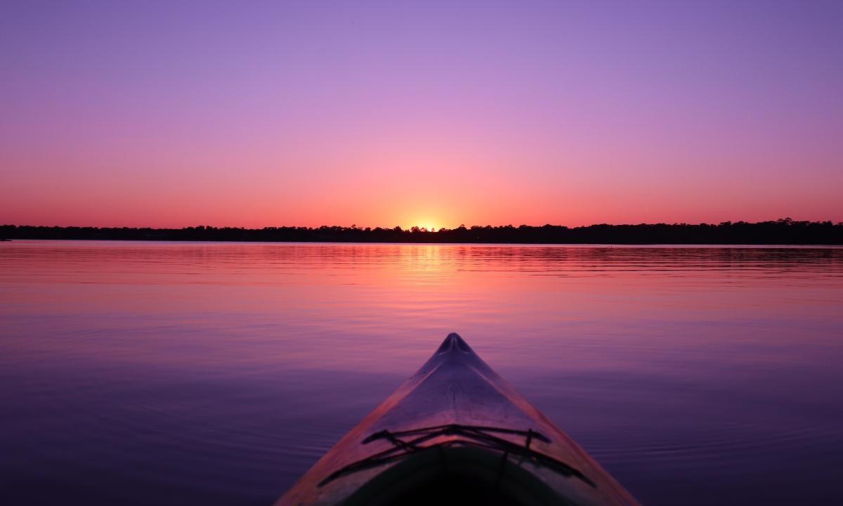Kayaking at sunset on a lagoon