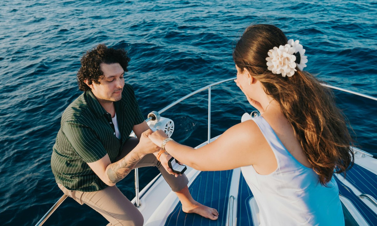 Chico pidiendo la mano a su pareja a bordo de un barco en La Palma durante un viaje romántico de San Valentín