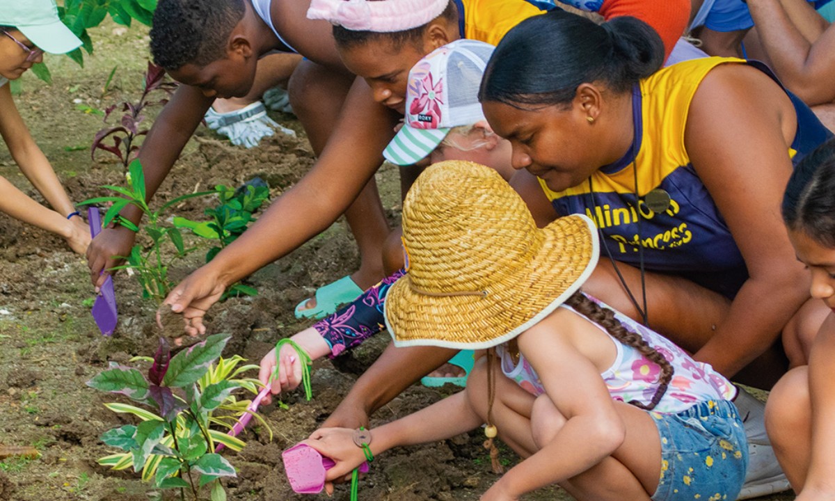 Children helping Princess Hotels employees collect rubbish