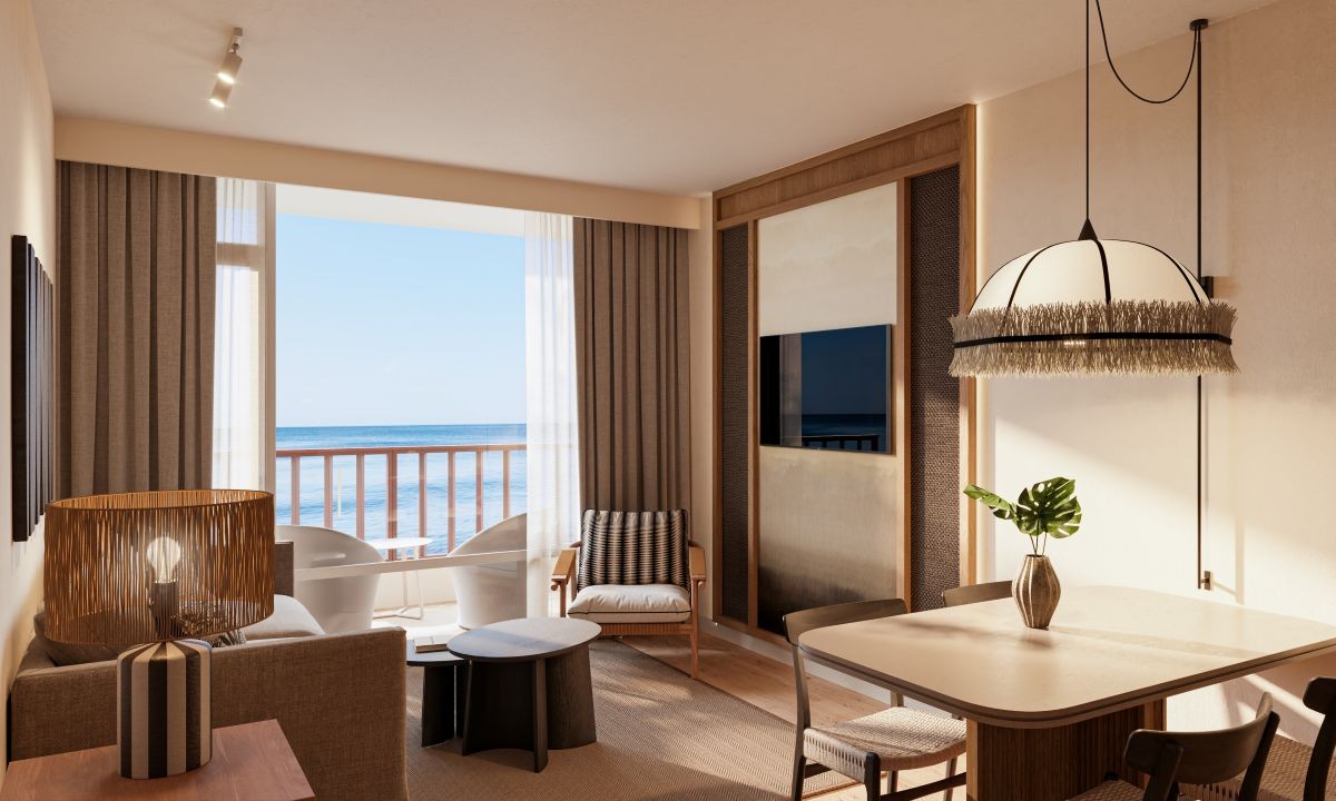 Separate living room of the suite, featuring a balcony with sea views
