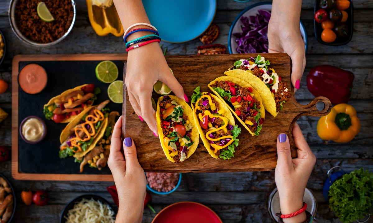 Women sharing a tray of tacos