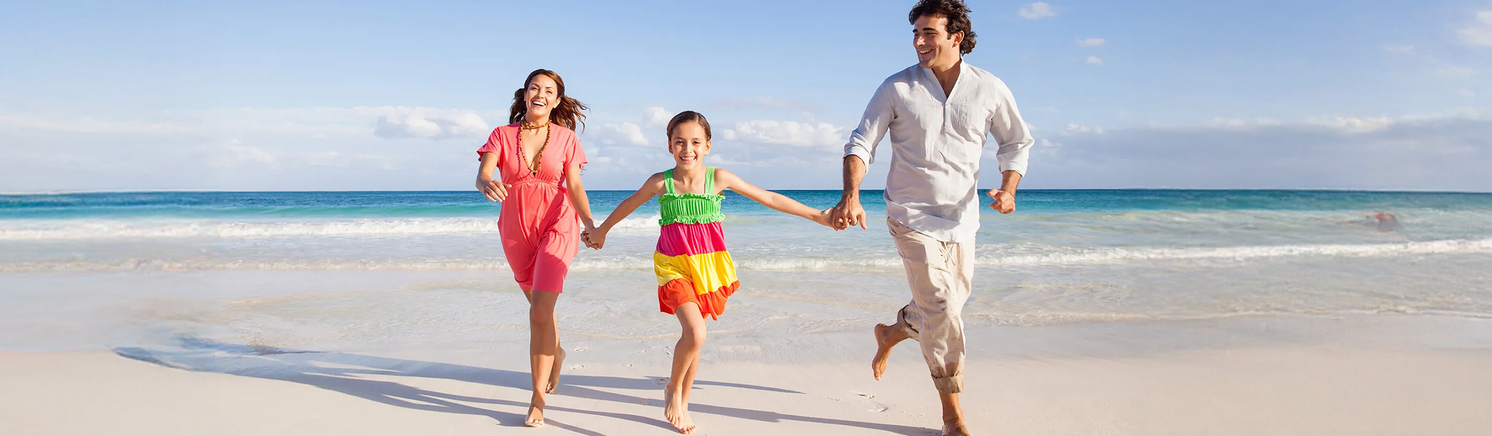 A couple with their daughter by the sea
