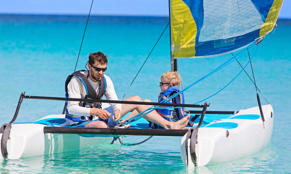 A father with his son on a catamaran