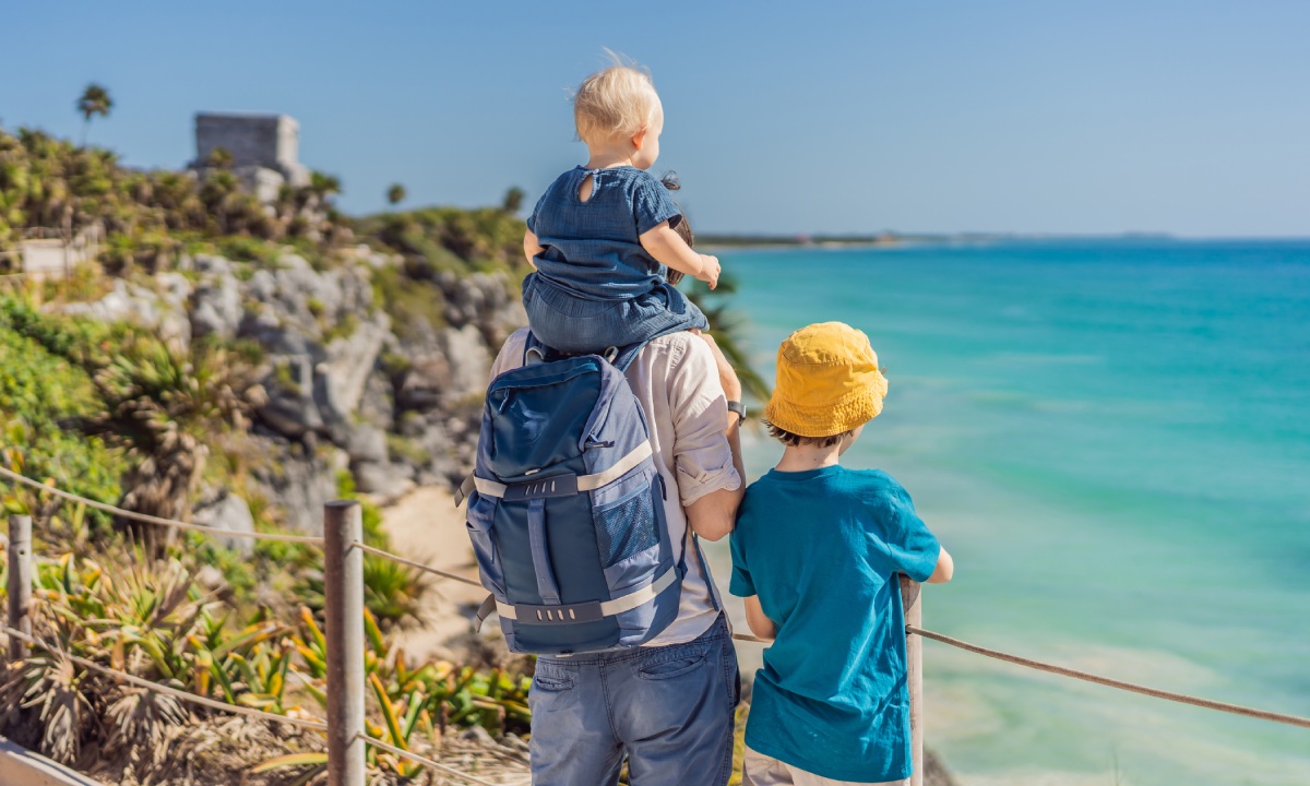 A father with his children on a road trip by the sea