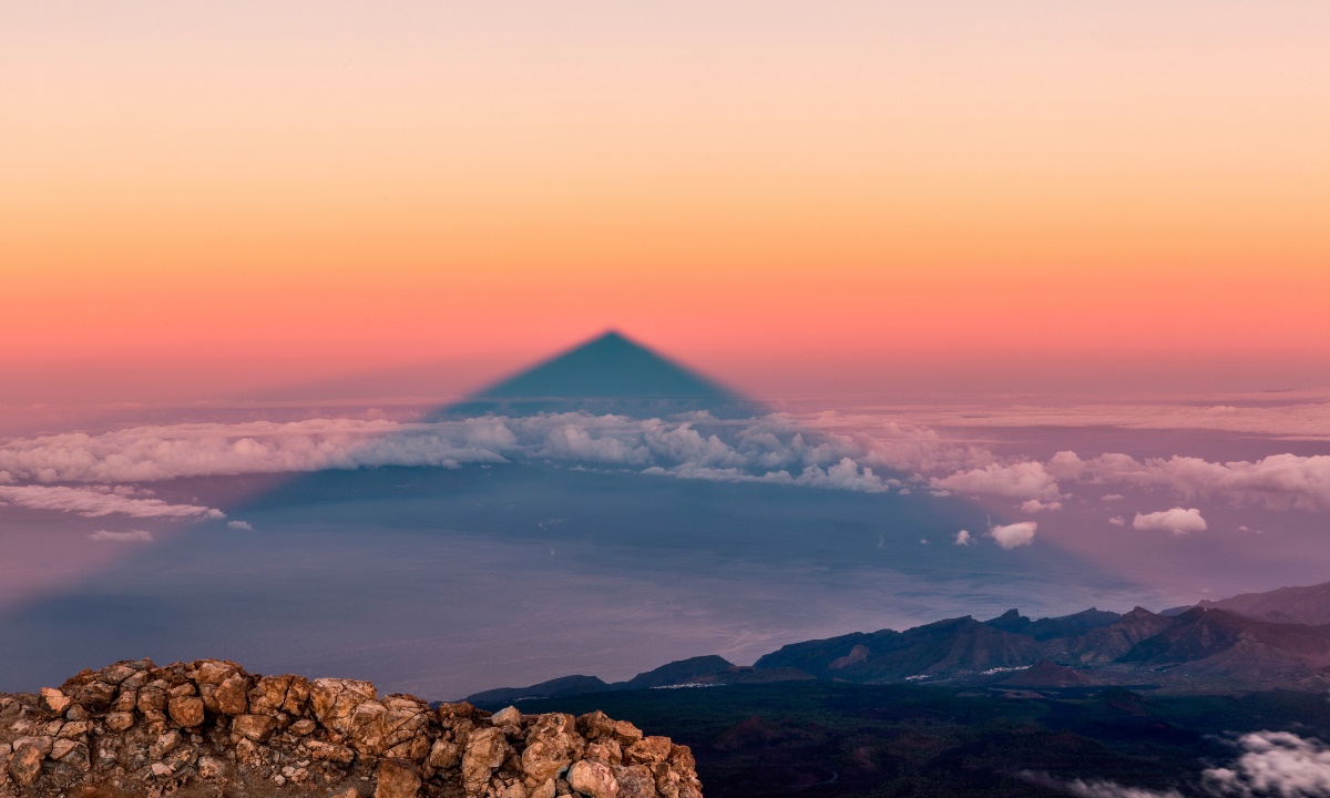 Mount Teide's shadow stretching across a sea of clouds at sunset