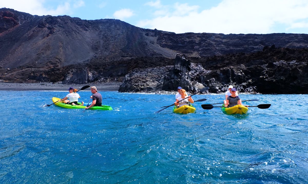 Personen beim Kajakfahren entlang der vulkanischen Küste von La Palma