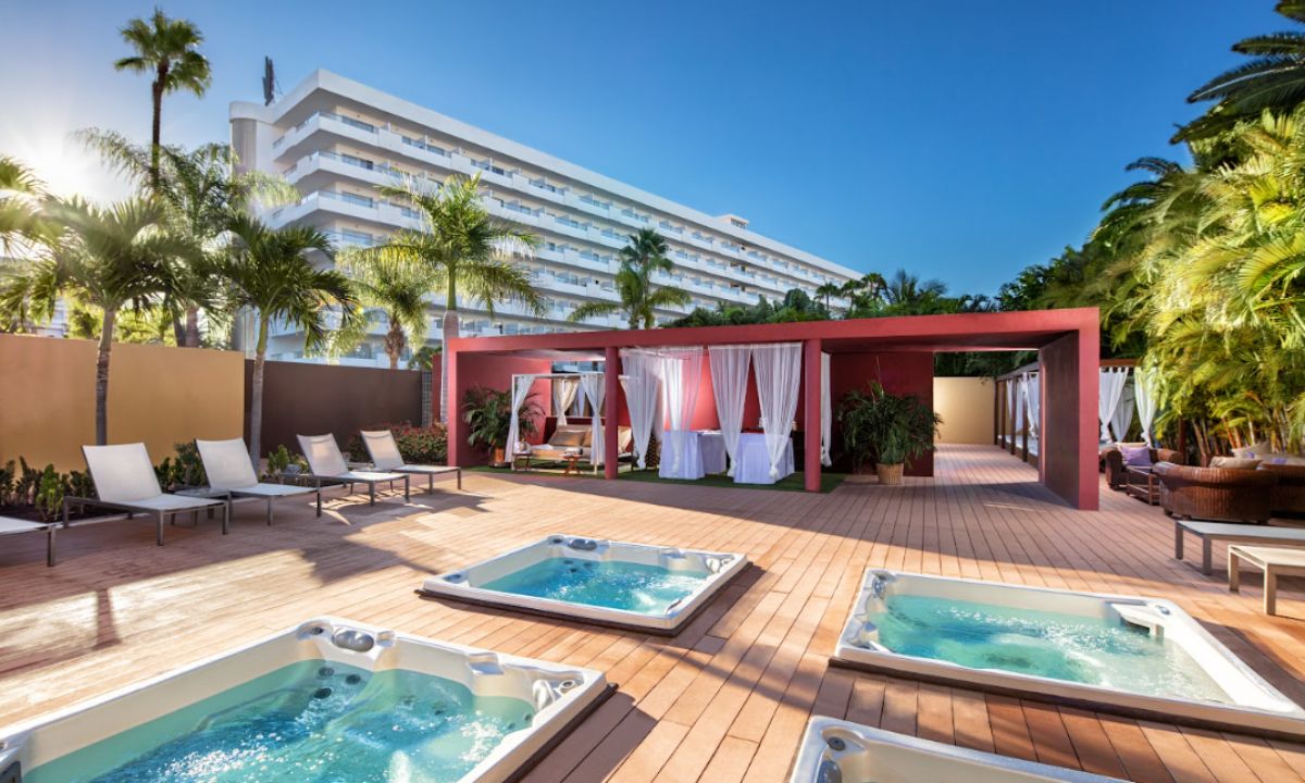 Zona wellness exterior del hotel Gran Canaria Princess con jacuzzis privados y camas balinesas.