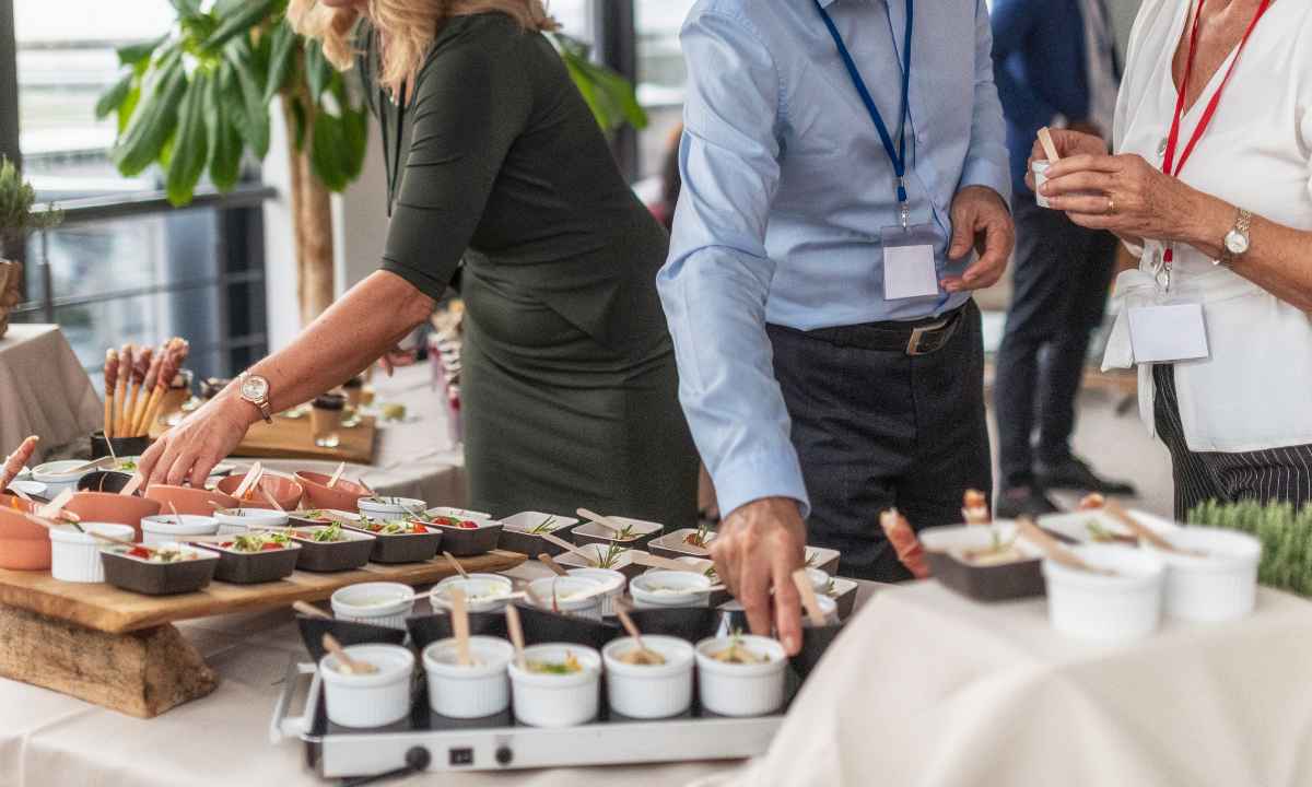 Sala de eventos moderna y buffet preparado para la reunión de empresa.