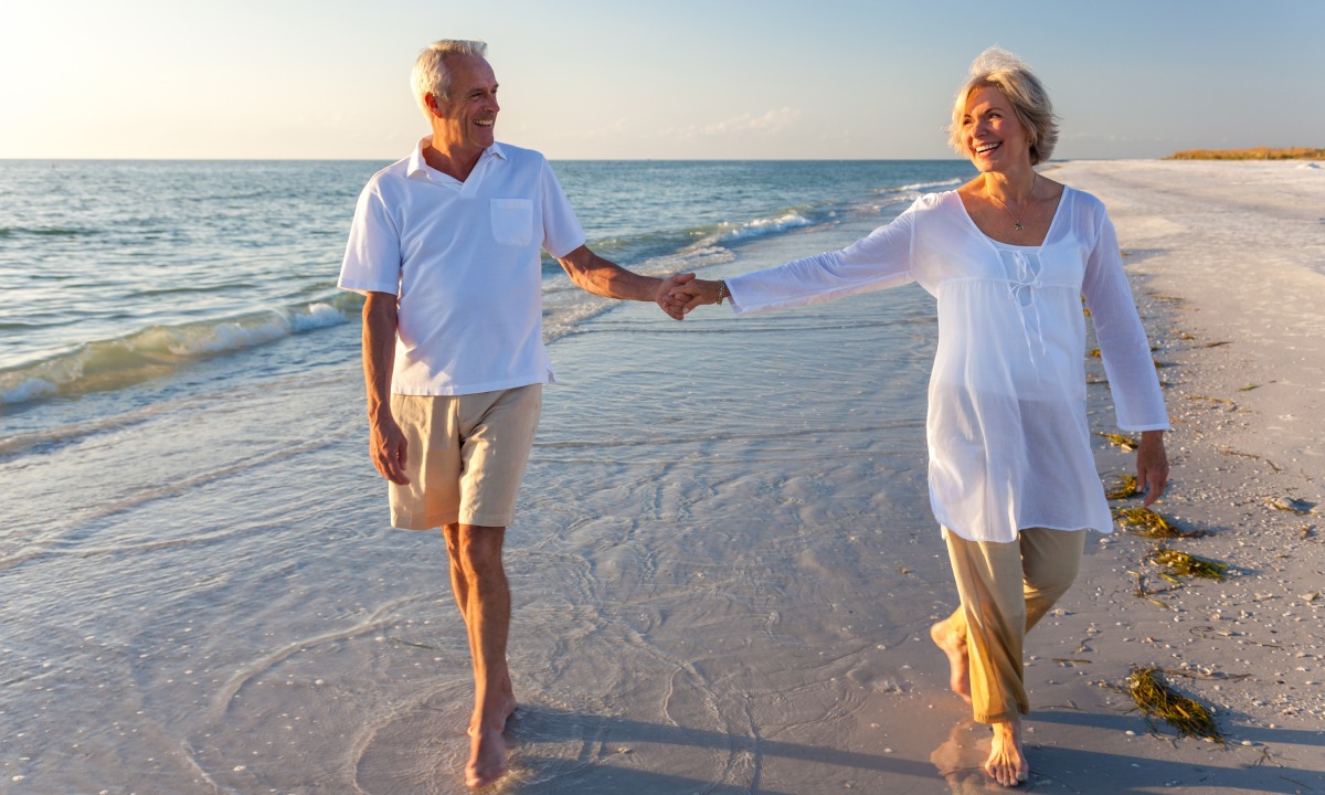 A couple strolling along the shore