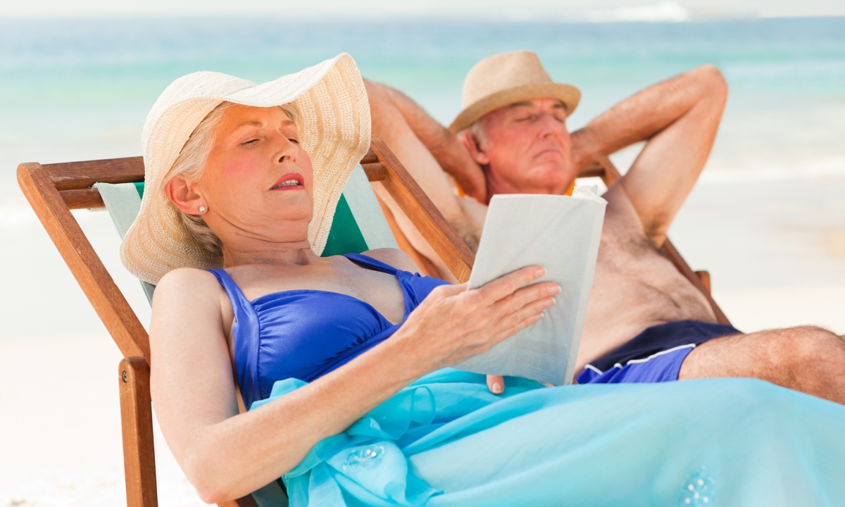 A man and a woman lying on sun loungers